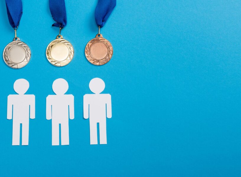 top-view-of-white-paper-cut-people-near-silver-and-2024-11-13-17-06-58-utc